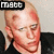 Pixelated image of a person with light skin and short hair, wearing dark clothing against a plain background.