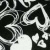 Pixelated grayscale icon with abstract swirling patterns and irregular shapes against a dark background.