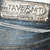 A silver-toned rectangular icon with rounded corners displays the text "TAMERLAN" in raised, stylized lettering against a dark blue background with horizontal light streaks.