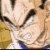 A pixelated character with spiky hair and a blue collar, shown in four of animation