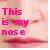 Pixelated text reads 'This is my nose' in red letters against a pink and beige gradient background with subtle green accents.