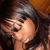 A woman with long dark hair covers her face with one hand in a pixelated image, showing slight variations across three views.
