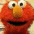 A 2x2 contact sheet of four distinct Sesame Street character frames with visible pixelation and dithering effects, showing Elmo in close-up, a green muppet waving, a red stick-figure Elmo next to a blue trash can, and an empty gray space.