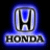 Blue and silver Honda logo with stylized 'H' emblem above the word 'HONDA' in block letters on a dark background.