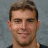 Pixelated portrait of a smiling man with short brown hair, next to text reading 'Tom Kostopoulos #36' and the Pittsburgh Penguins logo on white background.