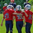 Pixelated image of three people in red shirts and dark pants standing on grass with orange text overlays reading "United We Aided We Sta" and "(P.R.I.D.E) #47 Brown MLB".
