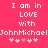 Pixelated text on a pink background reads "I am in LOVE with JohnMichaelJohnMichael" followed by six heart symbols.