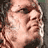 Pixelated close-up of a person's face with light skin tone, dark hair, and visible facial features including eyes, nose, mouth, and cheekbones.