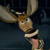 Pixelated cartoon moose with large antlers, brown face, white eyes with black pupils, and a pink tongue sticking out against a dark blue background.