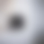 A pixelated grayscale gradient with a central dark square surrounded by lighter concentric rings on a light background.
