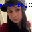 Pixelated image of a person with long dark hair wearing a black top and red garment, overlaid with blue text reading 'xenee bby<3' against a light background.
