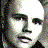 Four grayscale portraits arranged in a , each with distinct facial features and expressions, displayed in a pixelated style