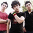 Three people stand side-by-side on a bright green background with red pixelated text reading Mrs, Joe, and Jonas.