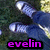 Pixelated image of a character with light blue hair and white highlights, wearing dark clothing against a blurred background with purple text reading 'evelin' at the bottom.
