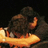 Two people embrace in a pixelated image with blue text overlays on purple and gray backgrounds.