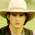 Static 50x50 pixel icon of a person wearing a light-colored wide-brimmed hat and dark jacket against a pale green background with visible dithering and low-resolution rendering artifacts.