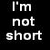 Pixelated text displays 'I'm not short' on left and 'I'm Vertically Challenged.' on right against black background.