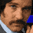 A contact sheet of five animated frames from an AOL Instant Messenger buddy icon featuring a man with dark hair and mustache, static noise effects, and diagonal text on blue background.