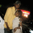 A pixelated image shows two figures embracing, one holding a glowing red and yellow object against a dark background.