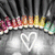 A pixelated image shows a white heart symbol on a gray background with colorful blurred shapes above it.