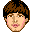 Pixelated cartoon head with brown hair and pink lips appears above a green apple, then the apple moves to the right while the head remains static.