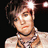 Pixelated close-up of a person with short dark hair, light skin, and a black choker necklace against a dark background.