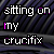 repeated text 'sitting on my crucifix' in white and purple pixelated font over a dark striped background with visible animation changes