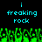 Pixelated cyan text 'i freaking rock' appears above green pixelated grass-like shapes on a black background.