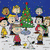 Animated scene with Peanuts characters around a Christmas tree, transitioning to a snowman and candy cane heart.