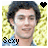 A pixelated image of a person with dark curly hair and light skin, wearing a blue shirt against a yellow textured background, with text overlays changing across frames.