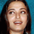 Pixelated close-up of a person with dark hair against a blue background, showing facial features and mouth in a static image.
