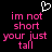 Pixelated pink text on black background with white heart symbol above, displaying 'im not short your just tall' in two identical