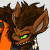 Pixelated character with brown spiky hair, green eyes, and a wide grin showing teeth, wearing an orange shirt and dark vest, with a fiery orange-and-white aura surrounding the head.