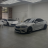 Pixelated static image of a silver sedan parked indoors with a blurred background showing a doorway and wall.