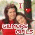 Pixelated image of two people with long dark hair, one in red clothing holding a heart symbol and the other partially visible behind them.