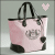 A pink and black tote bag with a stylized logo appears in two states: one with a light pink heart above it, the other with a dark gray heart.