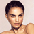Pixelated close-up of a person with short dark hair, light skin, and a neutral expression against a light background.
