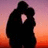 Silhouette of two figures embracing against a sunset sky with red and purple hues, next to red pixelated text reading "In Love Forever And Always" on black background.