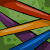 Animated contact sheet showing a yellow ribbon-like shape moving across colorful diagonal stripes on a green background with purple and blue accents.