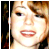 A pixelated close-up of a person's face with light brown hair, showing two sequential expressions: first neutral then smiling.