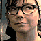 repeated head-and-shoulders portraits showing a person with dark-rimmed glasses and patterned hair, each in slightly varied poses against a blurred background