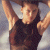 A pixelated contact sheet showing two frames of an animated icon featuring a person in a black sleeveless top with arms raised, next to green text reading "Original Icons .com" on a dark background.