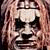 Static pixelated icon of a stylized face with dark eye patches and light skin tones against a brownish background.