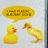 Yellow duckling and rubber duck face each other with yellow speech bubble containing text.