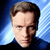Pixelated static image of a person's face with brown hair against a blue gradient background, rendered in low-resolution 8-bit style.