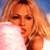 Pixelated static image of a person with light brown hair holding a pink fluffy object against a blue background.