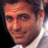 Pixelated close-up of a person's face with warm skin tones and dark hair, wearing a light-colored shirt against a gradient background.