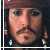 Static pixelated image of a person's face with brown hair and mustache, wearing dark clothing against a black background.