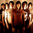 Pixelated group of figures with brown and white tones, yellow text on black background, static image.