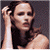 Pixelated image of a woman with dark hair and light skin, hand raised near her head against a gray background, next to green text reading "Original Icons .com" on a solid green field.